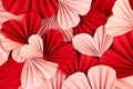 Fun Valentines day festive background in asian style - heap pink and red paper hearts of folded fans on gentle pastel pink color. Royalty Free Stock Photo