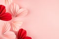 Fun Valentines day festive background in asian style - pink and red paper hearts of folded fans soar on gentle pastel pink color. Royalty Free Stock Photo