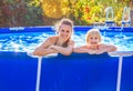 Happy active mother and child in swimming pool relaxing Royalty Free Stock Photo