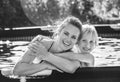 Smiling active mother and child in swimming pool embracing Royalty Free Stock Photo