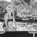 Smiling active mother teaching child to swim in swimming pool Royalty Free Stock Photo