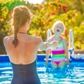 Smiling healthy mother and child in swimming pool playing Royalty Free Stock Photo