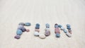 Fun word made of pebbles on a sandy beach Royalty Free Stock Photo