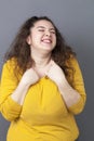 Fun xxl 20's woman expressing happiness with hands and face
