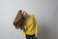 Fun young girl playing with her long brown hair for hair beauty