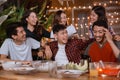 Fun young people laughing while having garden party at home