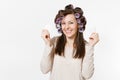 Fun young woman with curlers wipes her skin face with facial sponges isolated on white background. Crazy makeup with set Royalty Free Stock Photo