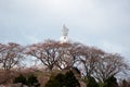 Funaoka Peace Kannon and cherry trees on the mountaintop of Funaoka Castle Ruin Park,Shibata,Miyagi,Tohoku,Japan. Royalty Free Stock Photo