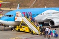 Funchal, Madeira - August 4, 2018: Tourists land on a plane at the airfields in Madeira