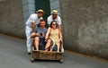 Funchal Madeira couple having downhill basket ride.