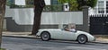 Classic White MGA Sports car being driven uphill in Funchal Madeira. Royalty Free Stock Photo