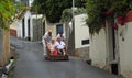 Funchal Madeira older couple having downhill basket ride.