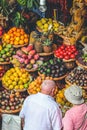 Funchal, Madeira, Portugal - Sep 21, 2019: Tourists buying fresh fruits and vegetables on the traditional market Mercado dos Royalty Free Stock Photo