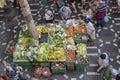 Fruit and vegetable sale at stall on decorated black and white flooring at covered market courtyard, Funchal, Madeira