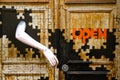 Surreal door red text open mannequin dummy female arm as handle on a puzzle painted entrance in Ã¢â¬ÅThe art of open doorsÃ¢â¬Â