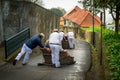 Funchal traditional sledge downhill riders in Monte park. Royalty Free Stock Photo