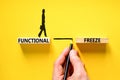 Functional freeze symbol. Concept words Functional freeze on beautiful wooden blocks. Beautiful yellowbackground. Businessman hand