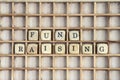 Fund raising sign made of dices on a dirty shelf