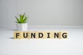 FUNDING word on wooden background composed from colorful abc alphabet block wooden letters, copy space for ad text. Learning