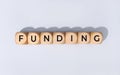 Funding word on wooden block