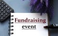 FUNDRAISING EVENT - words are written on a notepad with a marker, calculator and lavender sprigs