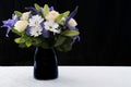 Funeral Bouquet purple White flowers, Sympathy and Condolence Concept on blackbackground with copy space Royalty Free Stock Photo