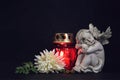Funeral candle, flower and angel figurine on black background Royalty Free Stock Photo