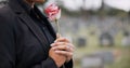 Funeral, cemetery and person with rose sad for remembrance, burial ceremony and memorial service. Depression, death and Royalty Free Stock Photo