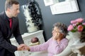 Funeral director holding hand elderly lady