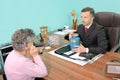 Funeral director in meeting with woman holding urn