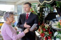 Funeral director showing woman memorial plaque