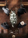 Funeral, family coffin and church above for death, grief or burial service with solidarity. Group, pallbearers and Royalty Free Stock Photo