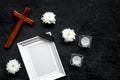 Funeral. Mockup of portrait of the deceased, of dead person. Frame with black ribbon near flowers, candles and cross on