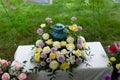 funeral and mourning concept - colorful flowers surrounding urn Royalty Free Stock Photo