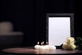 Funeral photo frame with black ribbon, roses and candles Royalty Free Stock Photo