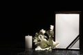 Funeral photo frame, burning candle and lily flowers