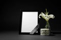 Funeral photo frame with ribbon, white lily and candle on black background Royalty Free Stock Photo