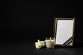 Funeral photo frame with ribbon, white rose and candle on background. Space for design