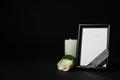 Funeral photo frame with ribbon, white rose and candle on dark table against background. Space for design Royalty Free Stock Photo