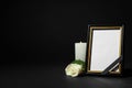 Funeral photo frame with ribbon, white rose and candle on table against black background. Space for design Royalty Free Stock Photo