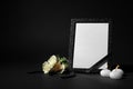 Funeral photo frame with ribbon, white roses and candles on background. Space for design Royalty Free Stock Photo