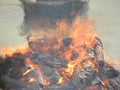 Funeral pyre with fire wood and flames at Cremation grounds