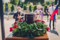 Funerary urn with ashes of dead and flowers at funeral Royalty Free Stock Photo