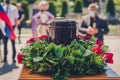 Funerary urn with ashes of dead and flowers at funeral Royalty Free Stock Photo