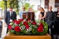 Funerary urn with ashes of dead and flowers at funeral Royalty Free Stock Photo