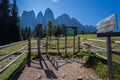 Signposts on the trail of the Natural Park Puez- Odle with The Odle mountains group on the