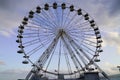 Funfair circle round attraction ferris wheel in daylight city