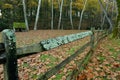 Fungus and moss covered fence surrounding a sheep feeding field Royalty Free Stock Photo