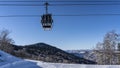 A funicular cab with attached skis moves along ropes