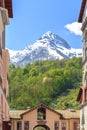 Funicular, green forests and snow-capped mountains in spring